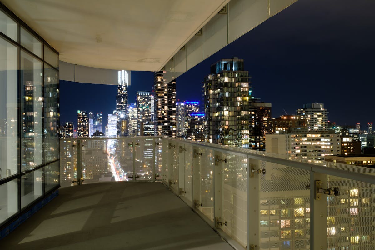 A city apartment balcony at night, the typical setting for apartment cannabis consumption